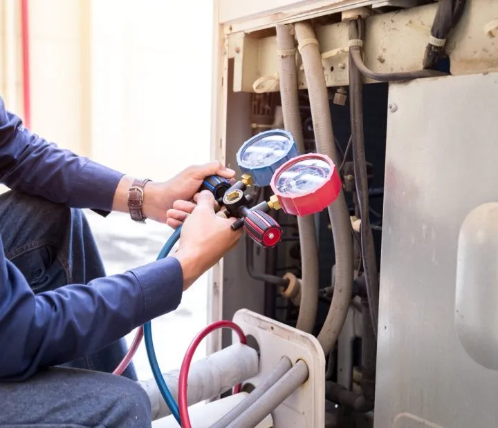 HVAC Repair A skilled technician holding a pressure regulator gauge of a heating system